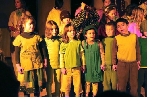 Students hold hands and sing, honouring the winter cycle through shared music and community connection at Kindlehill.