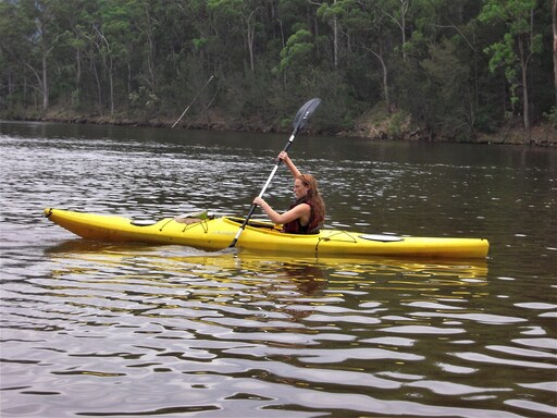 A Kindlehill student paddles through morning mist, fostering resilience and a deep connection to Country and nature.