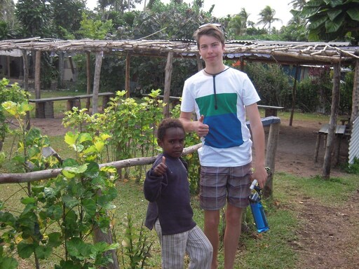 A student and local child share a connection, honouring global citizenship and Kindlehills spirit of cross-cultural community.