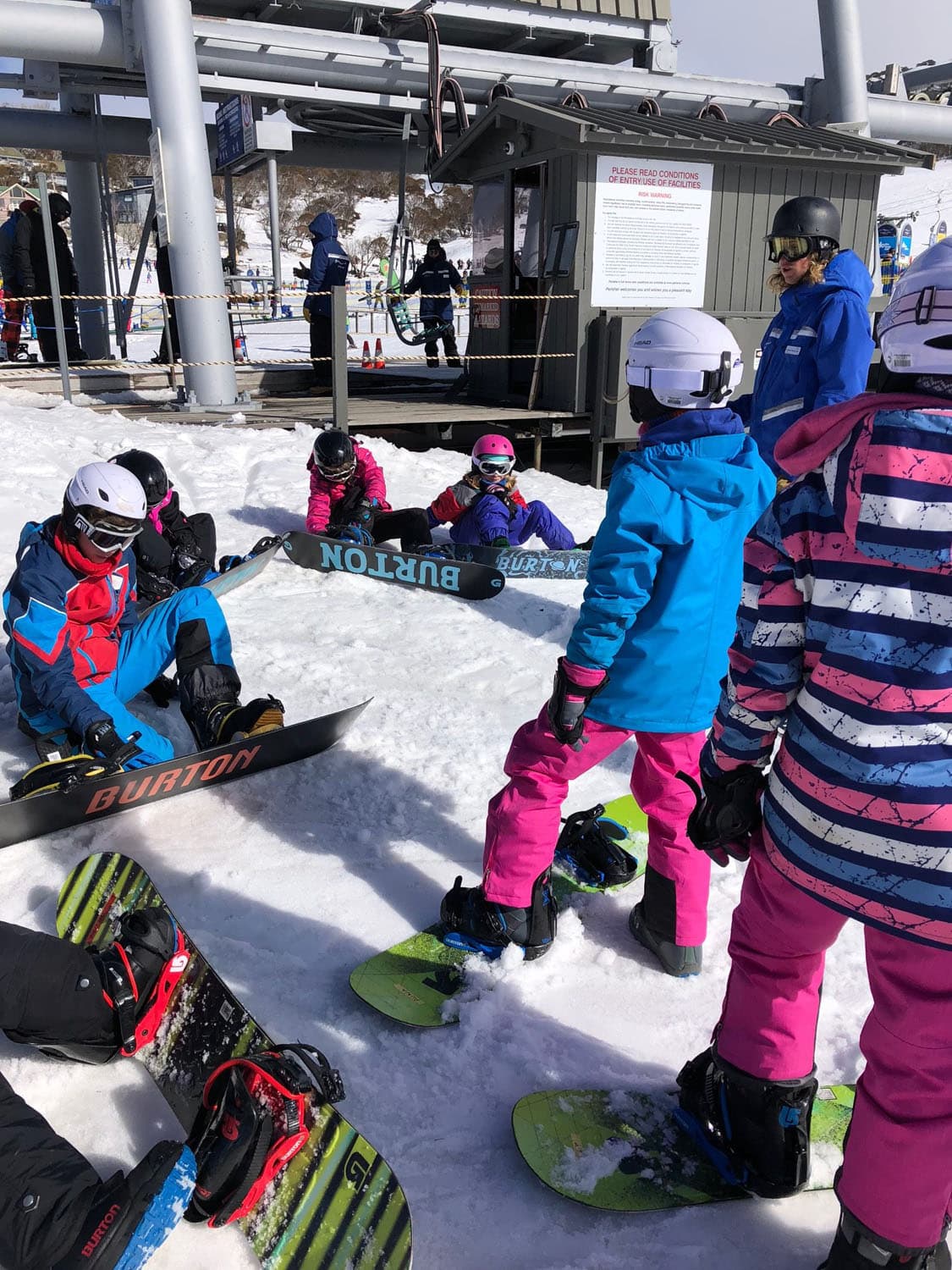 Determined Kindlehill students foster resilience and connection while learning to snowboard together during a winter mountain excursion.