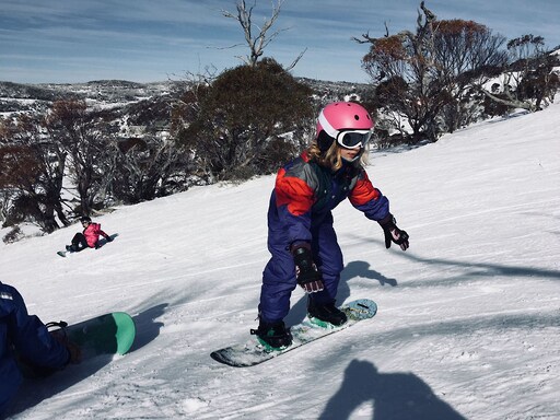 Determined students build resilience and friendship while learning to snowboard within a seasonal, snowy landscape.