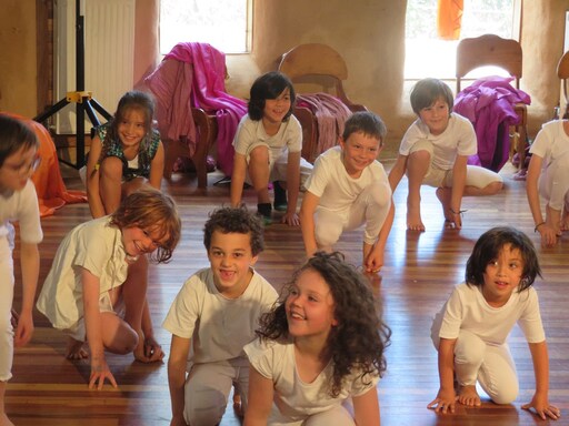Class 1/2 students joyfully perform their seasonal play, embodying Kindlehills creative spirit and deep connection to natural rhythms.