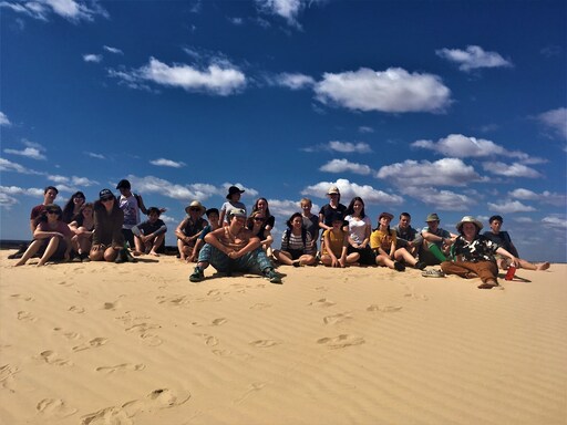 Kindlehill students sit together on ancient dunes, honouring Country and fostering a deep connection to the living world.