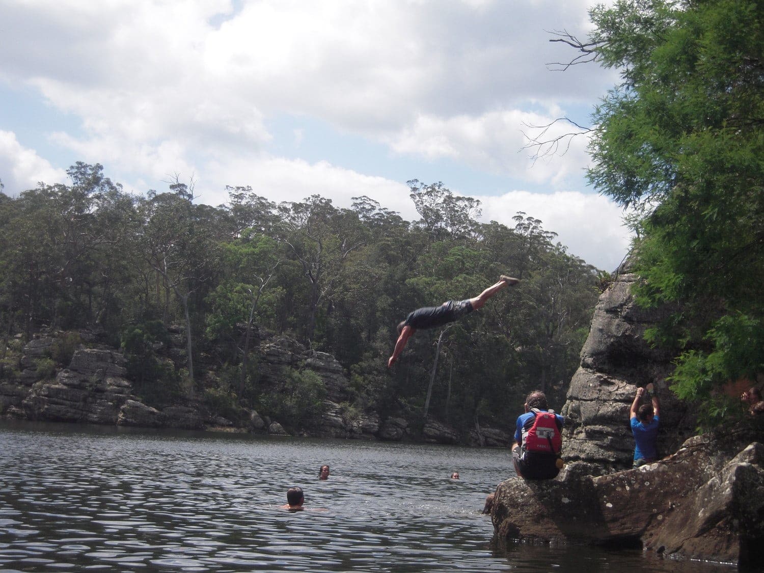 High school students cultivate resilience and connection, diving into the river during a Kangaroo Valley canoeing expedition.