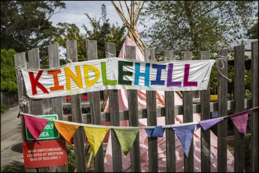 Colourful bunting and a hand-stitched banner reflect Kindlehills vibrant, nature-centred community spirit and harmonious village culture.