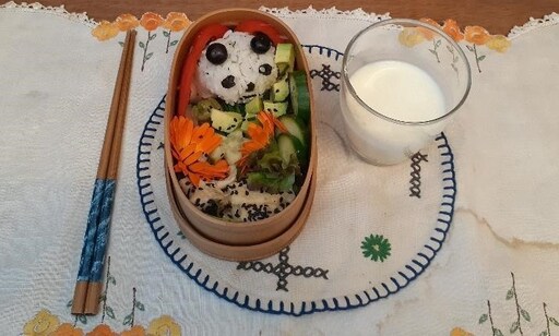 Hand-crafted panda rice and colourful garden vegetables express imagination and cultural connection through a students artistic edible creation.