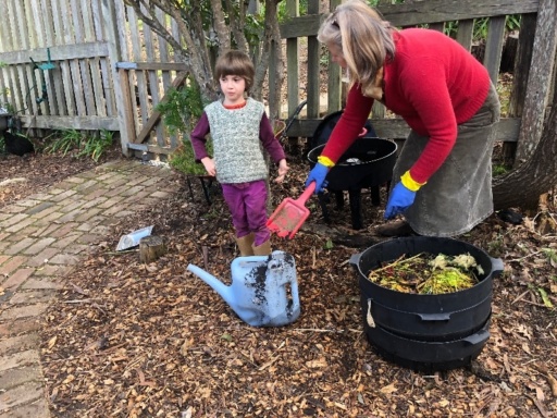 A Kindy teacher and student foster earth centredness while exploring practical science in the school garden compost.