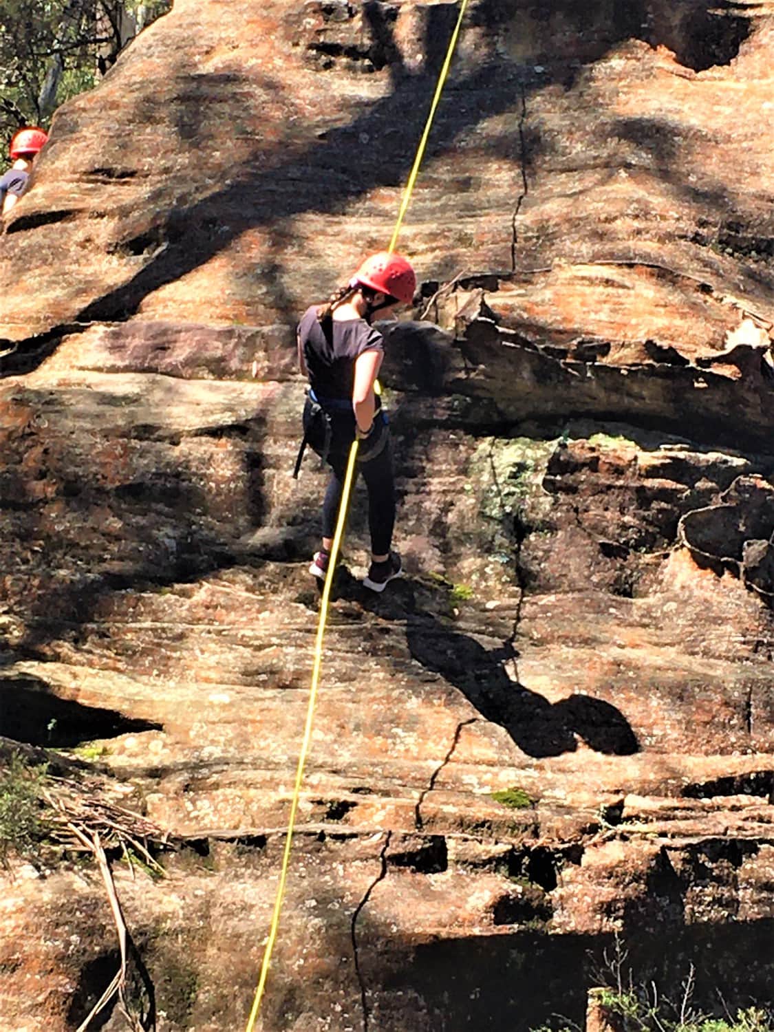 A Kindlehill student abseils sandstone cliffs at Mt Victoria, building personal challenge and resilience through connection to Country.