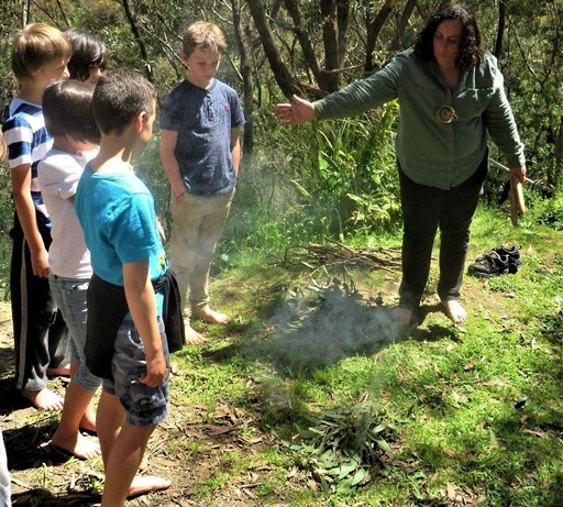 Aunty Corina leads Kindlehill students in a traditional smoking ceremony, honouring First Nations culture and connection to Country.