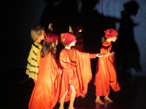 Kindlehill students perform Aanikas quest in glowing costumes, awakening imagination and collective spirit through shared artistic storytelling.
