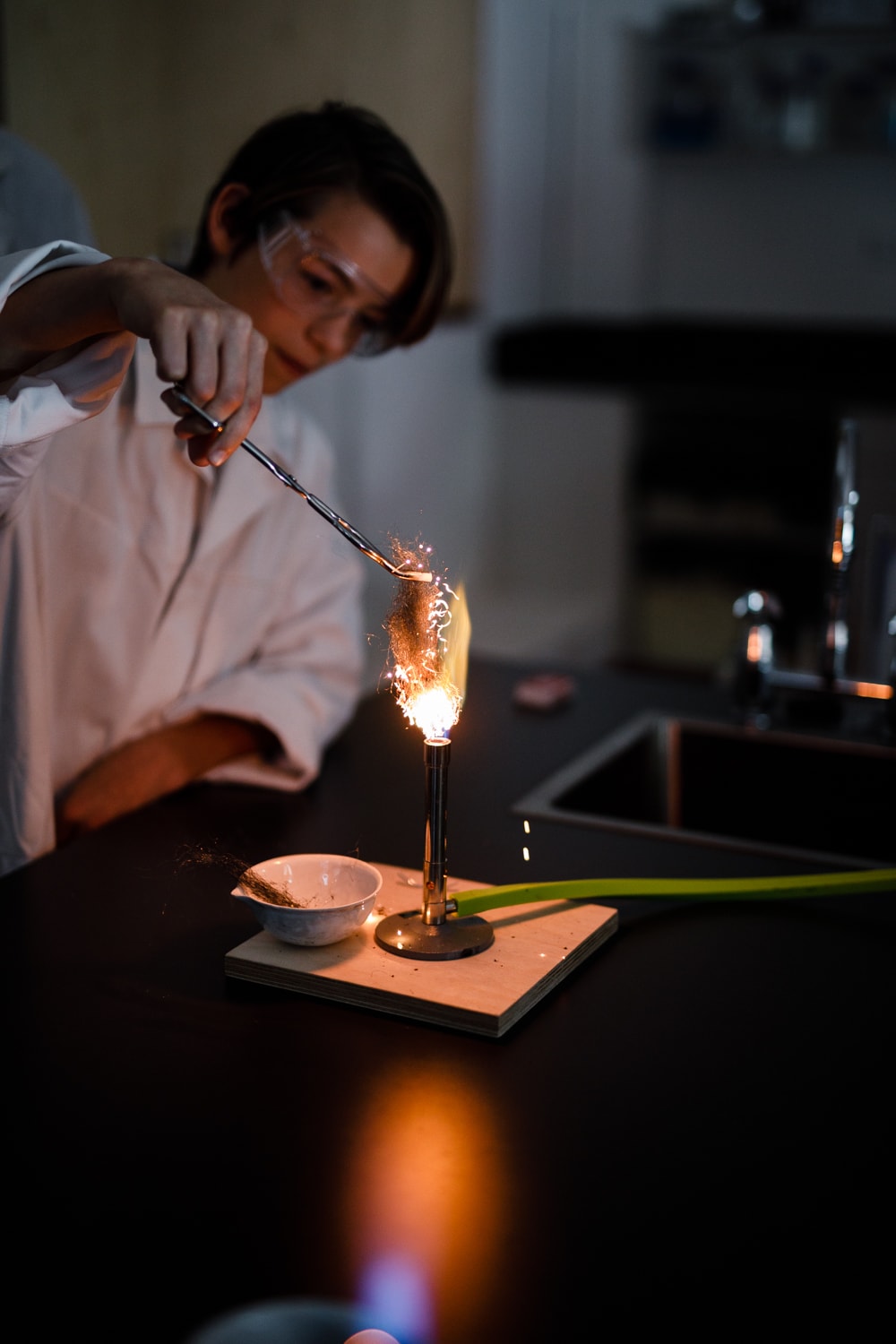 Kindlehill student explores chemical reactions with focused wonder, bridging scientific theory and hands-on holistic learning.