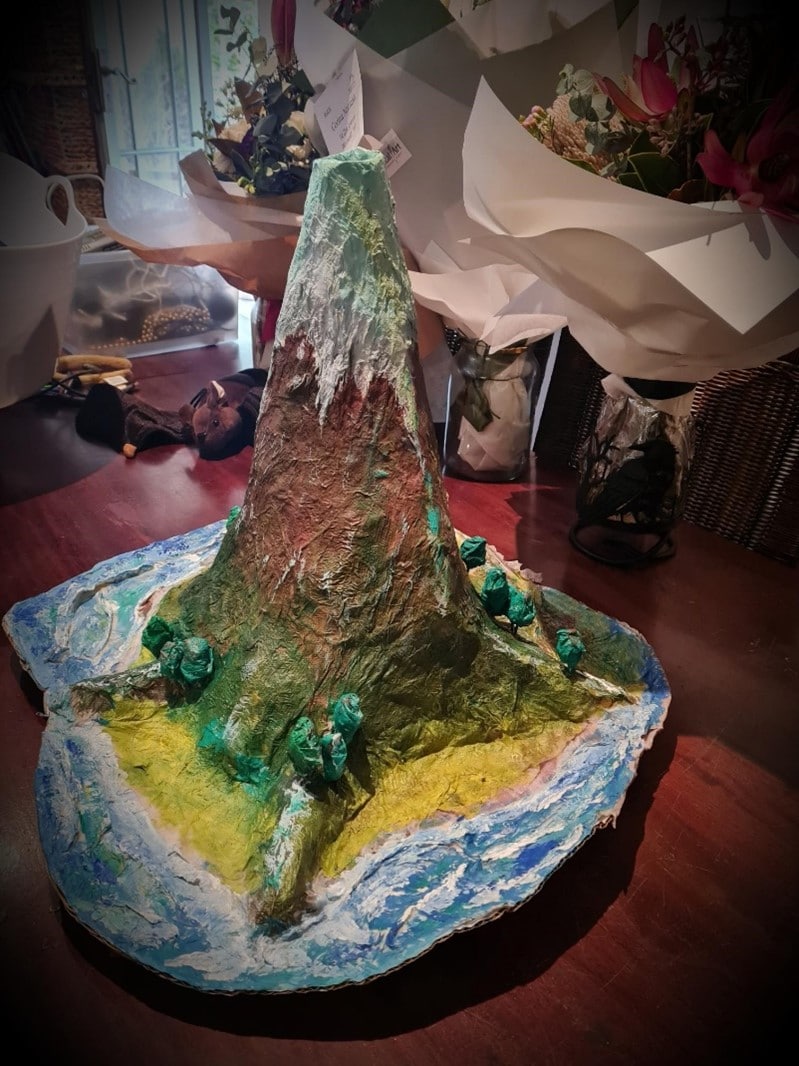 Malakais magnificent handcrafted volcanic island model showcases imaginative learning through artistic expression, connecting the home to geographic wonders.