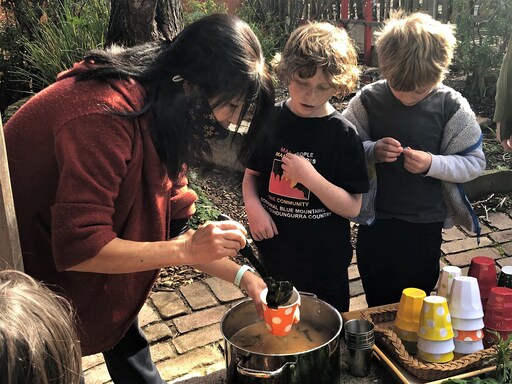 Kindlehill students and staff share nourishment in the garden, honouring global peace and fostering connection to the world.