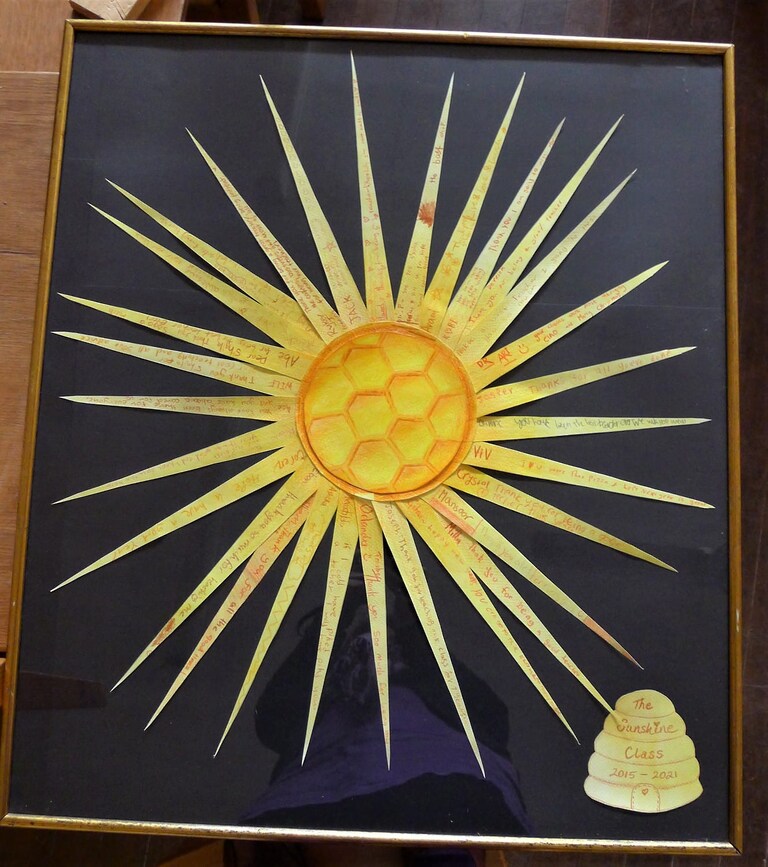 Handwritten rays of gratitude form a radiant sun, honouring the collective light and community spirit of Kindlehill.