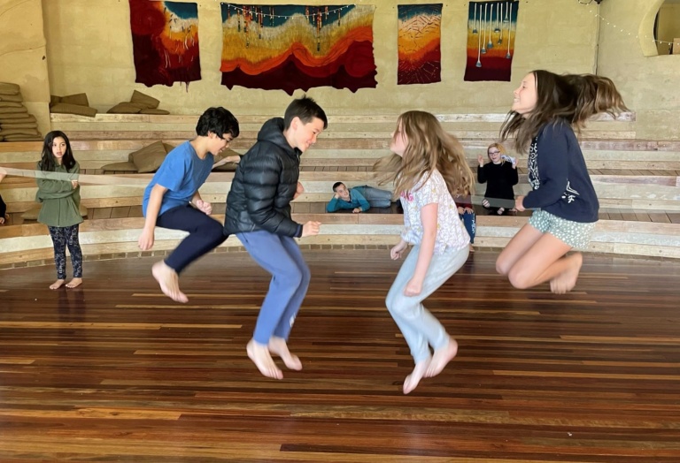 Joyful students leap in rhythmic skipping, celebrating the beauty of ordinary togetherness and the shared will to achieve.