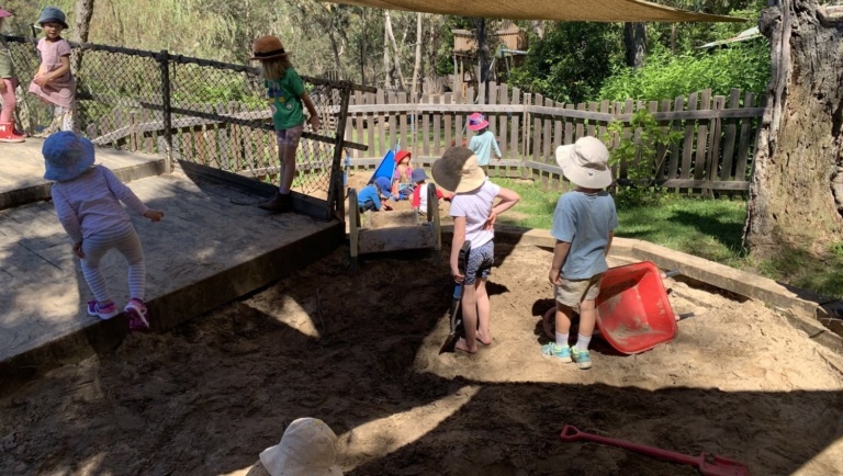 Children foster friendship and belonging in Kindlehills garden, socialising in a sheltered harbour of rhythmic outdoor play.