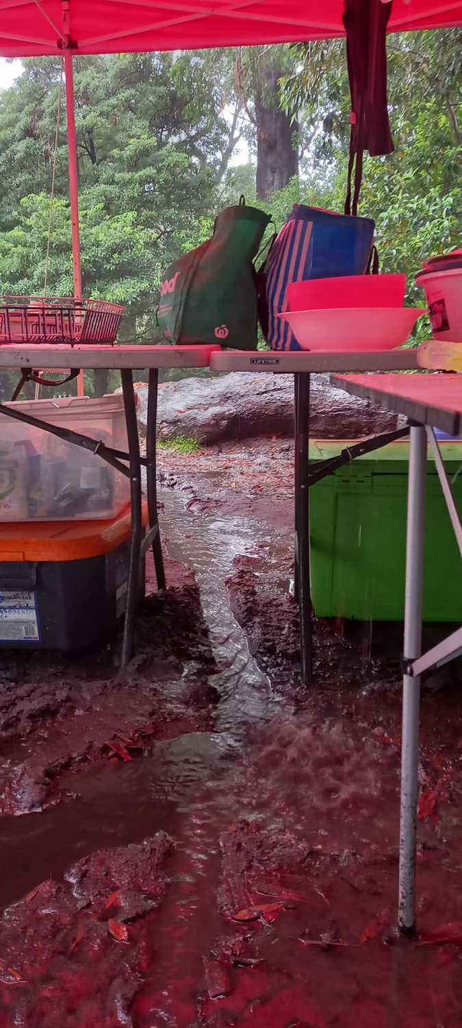 Rainwater flows through a muddy campsite, fostering resilience and a deep connection to the wildness of nature.