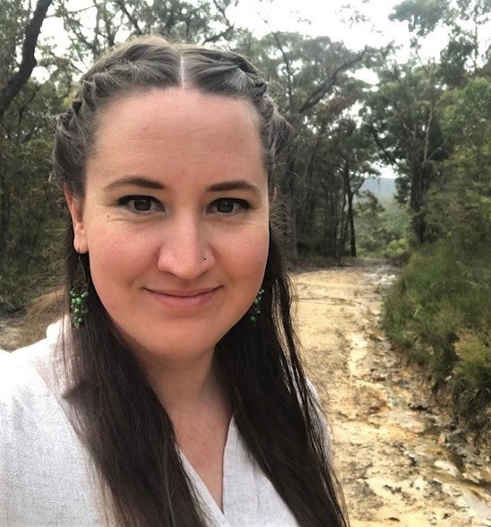 A Kindlehill teacher stands in the Blue Mountains bush, embodying the schools deep connection to Country and learning.