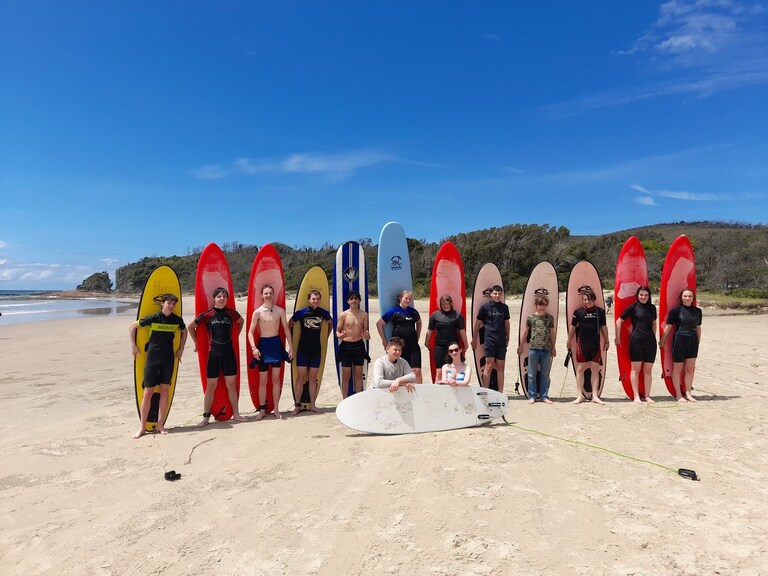 Kindlehill students cultivate social connection and resilience while surfing during their place-based learning camp at Crowdy Bay beach.
