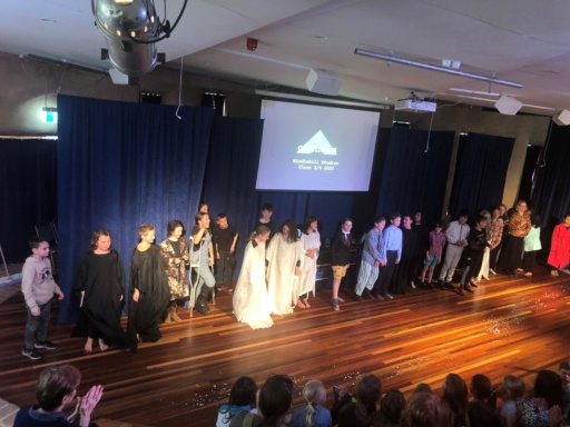 US honoring). Final Draft: Class 5-6 students bow after their play, celebrating creative courage, resilience, and community connection through artistic expression. 17 words. Lets ensure