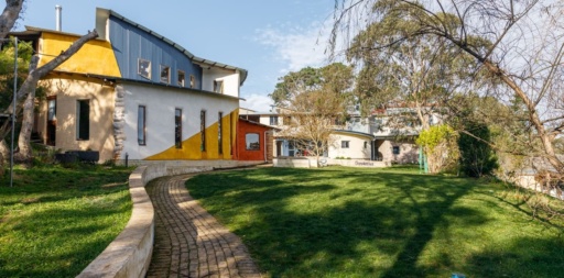 Vibrant, organic buildings and garden paths create a sensory-rich landscape for childhood development at Kindlehill Steiner School.