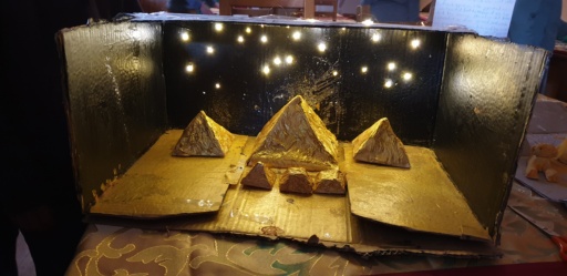 Hand-crafted golden pyramids beneath shimmering stars honour students creative exploration and wonder for ancient Egyptian history.