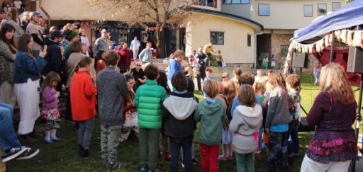 Families and children gather for the Kindlehill Autumn Fair, building community connection through music and shared seasonal celebration.