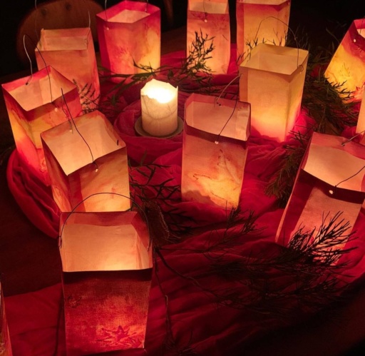 Handmade paper lanterns glow amongst native foliage, honouring communal connection and seasonal rhythms through shared light.