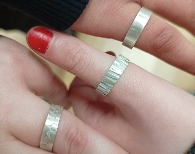 Handcrafted sterling silver rings feature textures inspired by nature, representing Kindlehill students connection to land and their artistic growth.