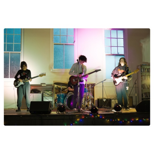 Kindlehill students perform live music on stage, showcasing their creative voices through collaborative artistic expression and community connection.