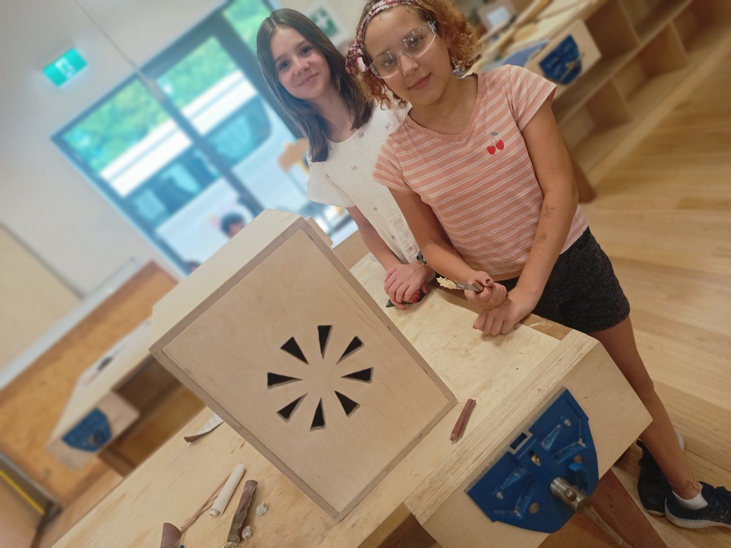 Two Kindlehill students practise woodcraft, transforming raw timber into a functional box with patience and focused skill.
