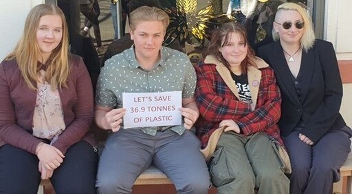 Kindlehill students demonstrate community spirit, holding a sign advocating to save thirty-six point nine tonnes of plastic.