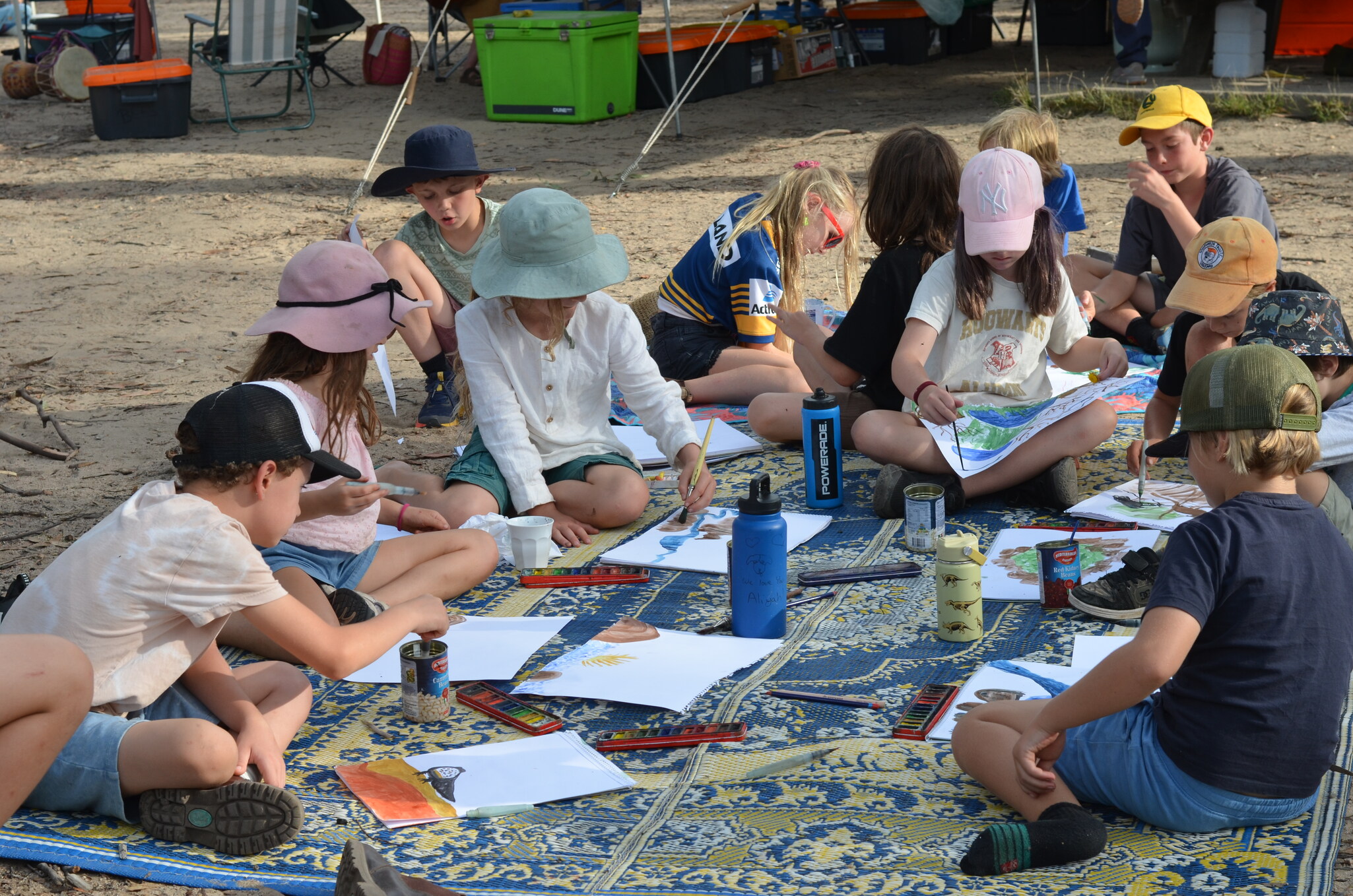 Kindlehill students gather at Ganguddy to watercolour paint nature scenes, fostering community during their school camping adventure.