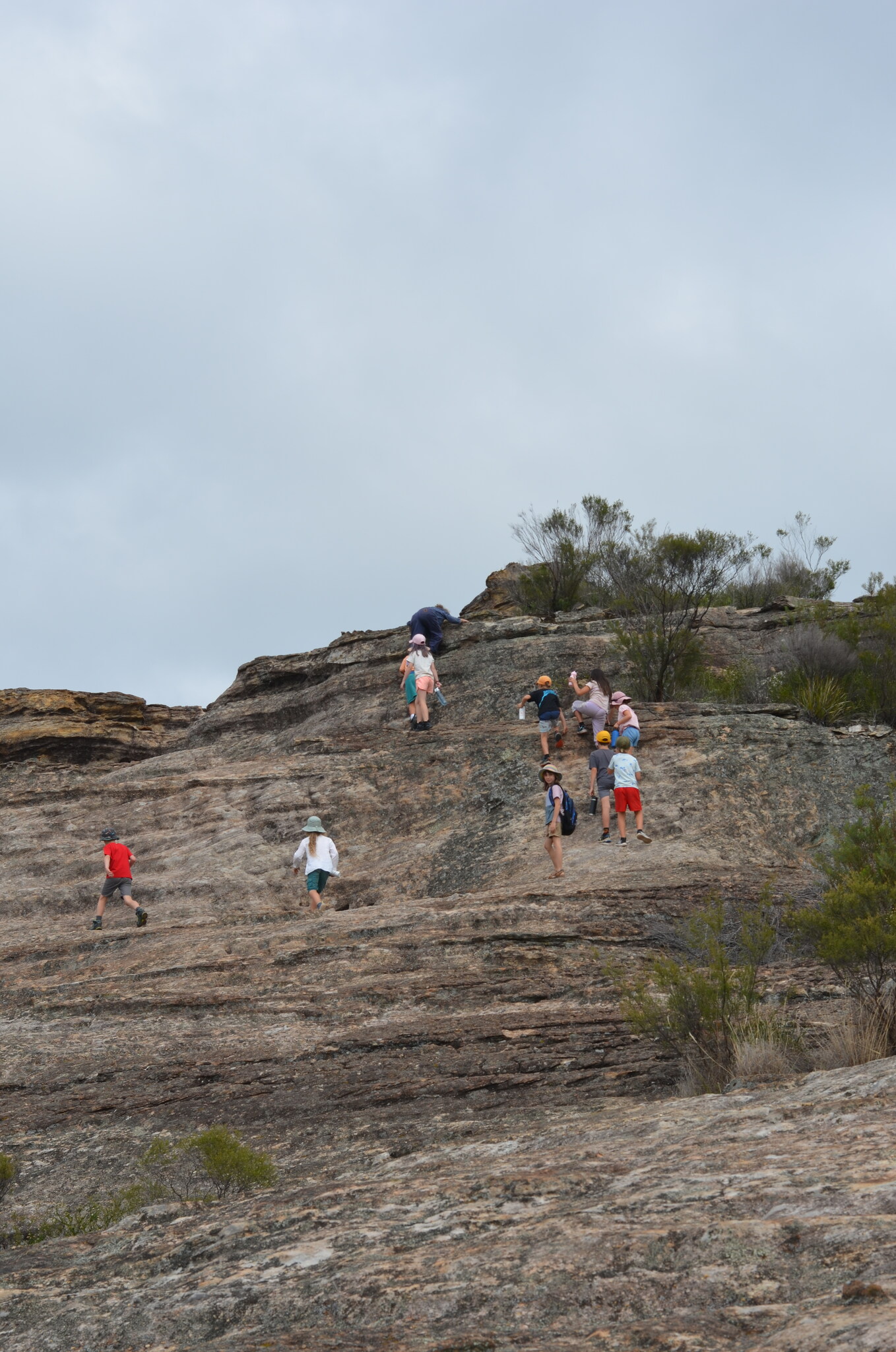 Kindlehill students scale rocky pagodas at Ganguddy, building resilience and independence through a shared adventure on Country.