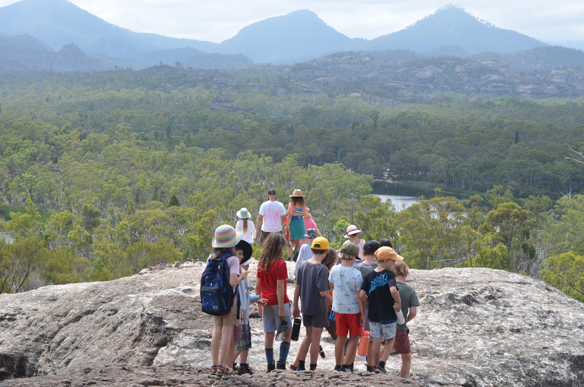 Kindlehill students overlook the Ganguddy wilderness, fostering resilience and deep connection to Country through shared natural exploration.