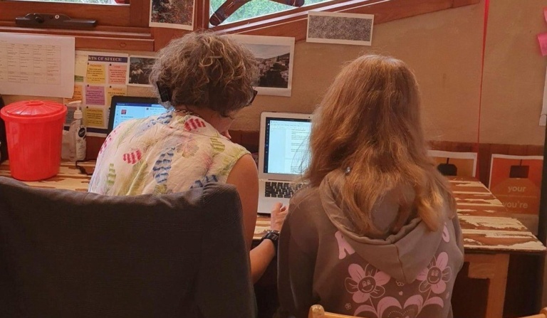 A teacher and student collaborate closely, fostering a reflective and personalised approach to their shared learning journey.