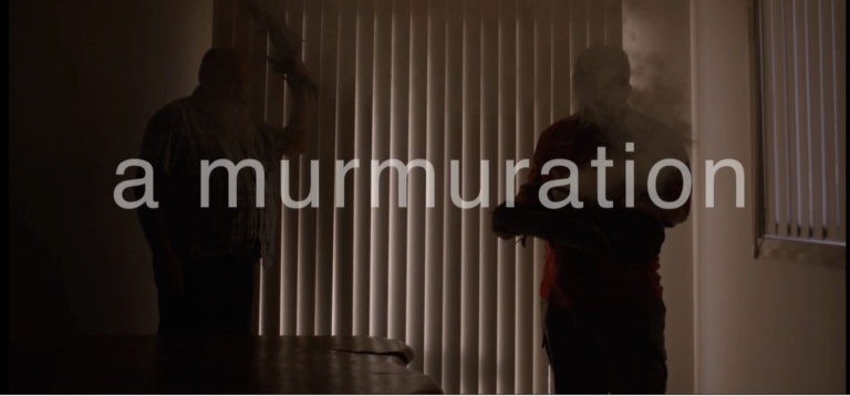 First Peoples lead a healing smoking ceremony, symbolising communal connection to Country under the film title a murmuration.