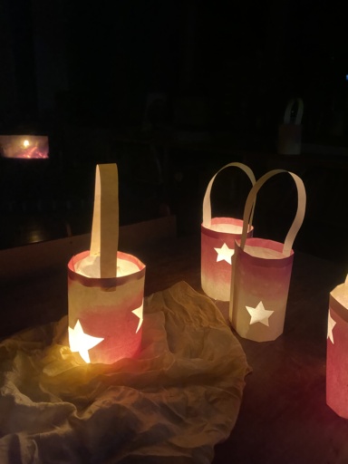Handmade star lanterns shine in the darkness, symbolising communal hope and the renewal of light at Kindlehill.