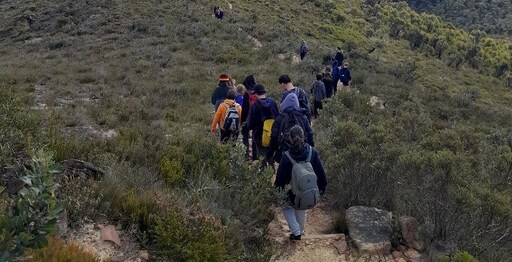 Kindlehill students hike along a bush track, realising deep connection to Country and community through shared outdoor adventure.
