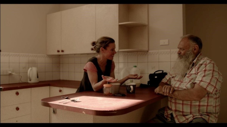 Dharug Elder Uncle Colin Locke and a teacher foster healing and connection through storytelling in a kitchen setting.