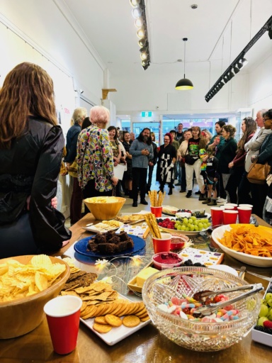 Diverse community members gather at a gallery to empower youth through art, celebrating identity and strengthening social connection.