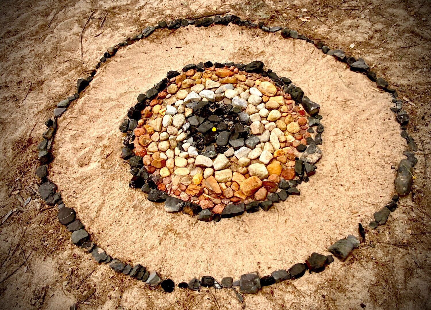 Concentric circles of natural stones reflect an artistic connection to Country and a mindful bond with the land.