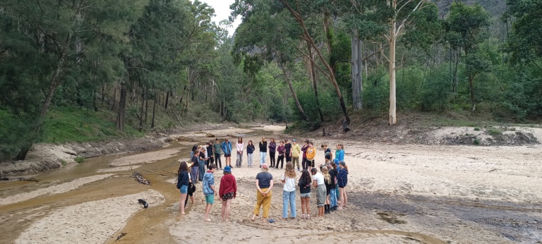 Kindlehill students gather in a circle on Wiradjuri Country, fostering connection and belonging within the vast landscape.