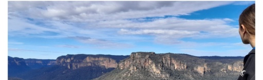 A young person overlooks the Grose Valley, connecting deeply with the ancient landscape and stories of Country.