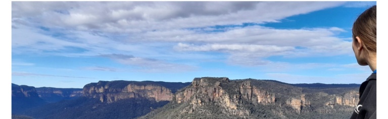 A young person overlooks the Grose Valley, connecting deeply with the ancient landscape and stories of Country.