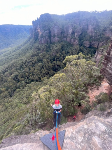 A student abseils at Narrowneck, cultivating courage and resilience through outdoor learning in the majestic Blue Mountains wilderness.