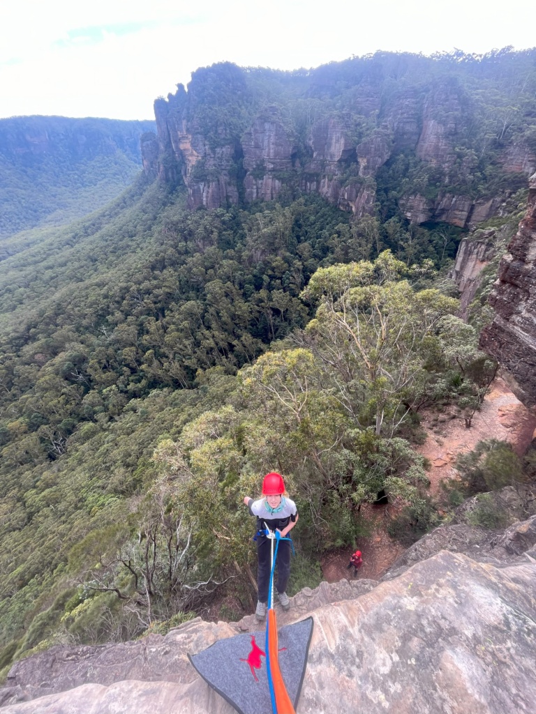 A student abseils at Narrowneck, cultivating courage and resilience through outdoor learning in the majestic Blue Mountains wilderness.