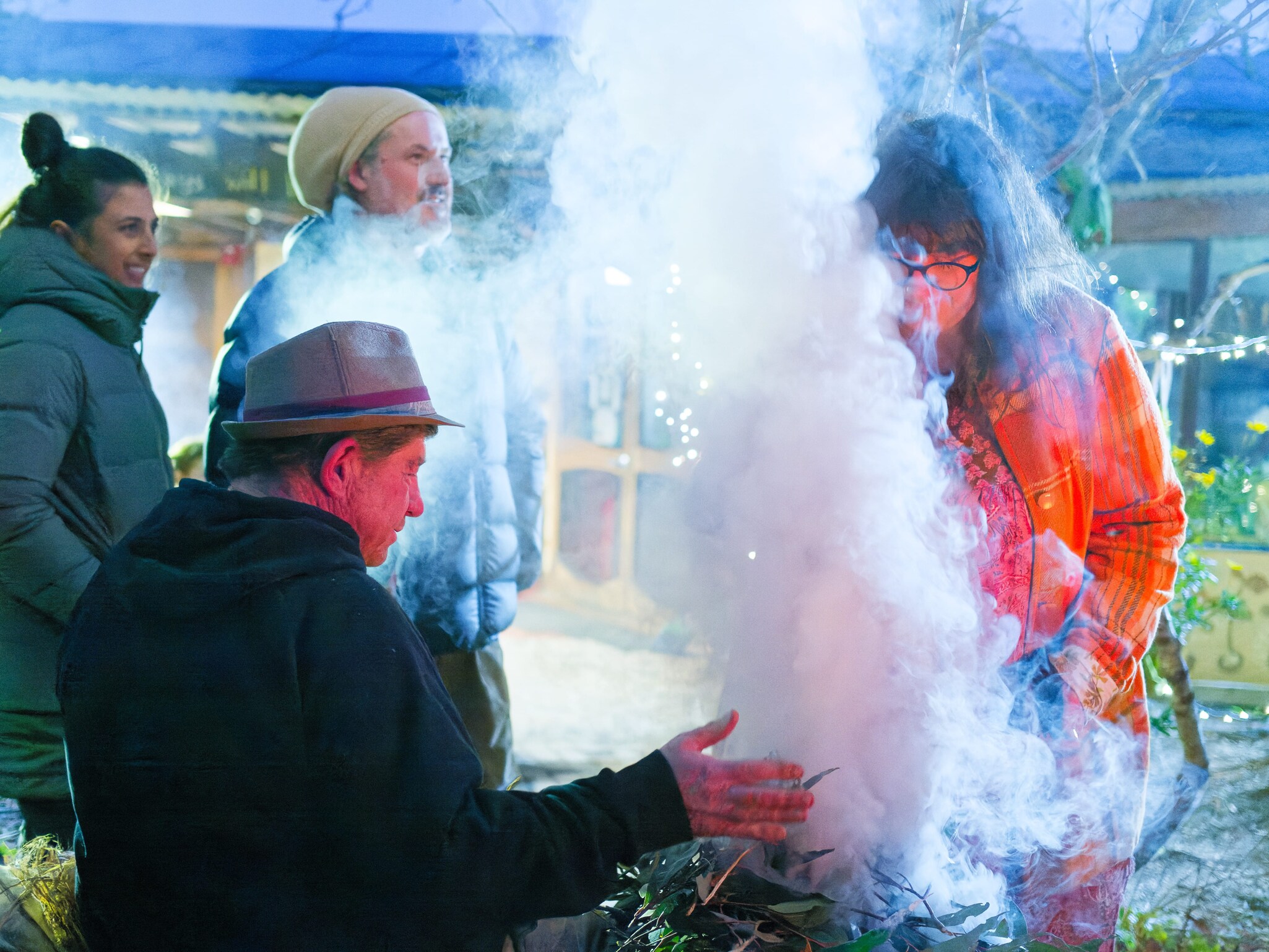 Community members share a winter smoking ceremony, honouring sacred rituals of light, hope, and connection to Country.