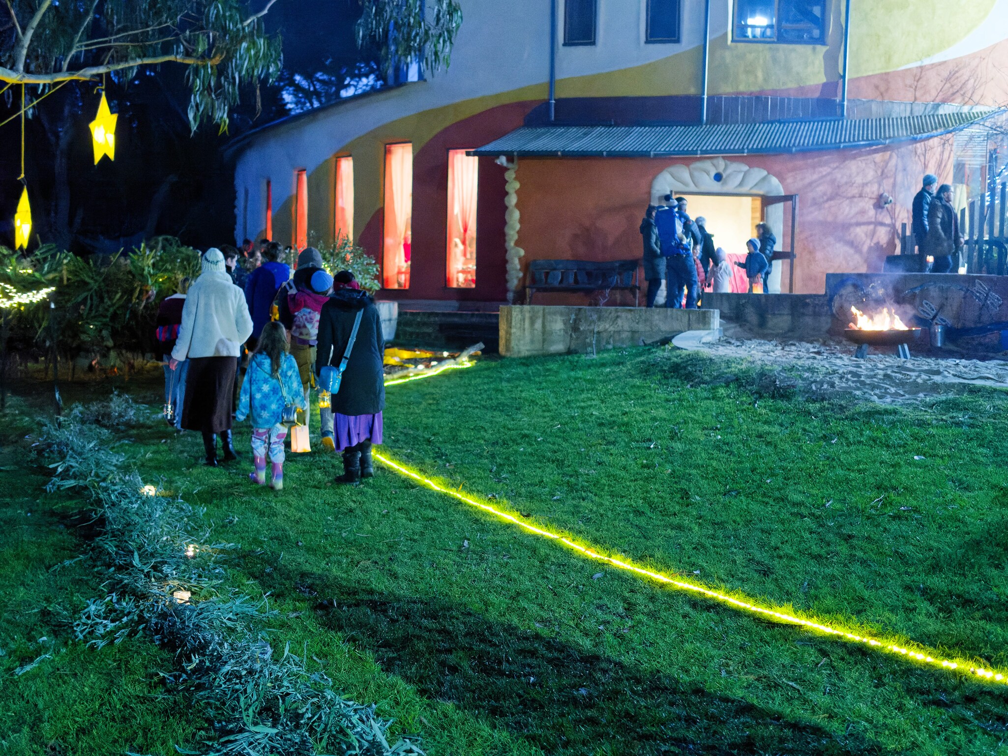 Kindlehill families follow a golden path, gathering for community rituals of warmth, light, and hope on Winters Night.