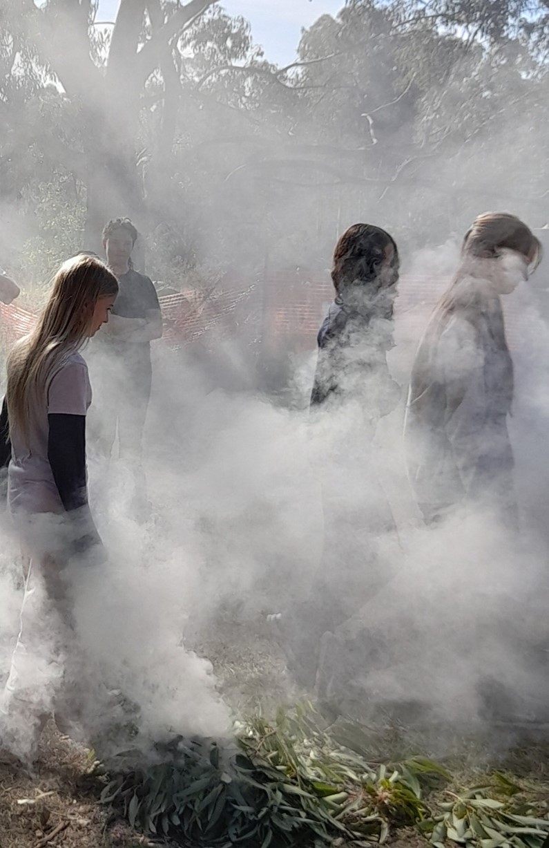 Students walk through a traditional smoking ceremony on Country, honouring First Peoples wisdom and deepening their connection to land.